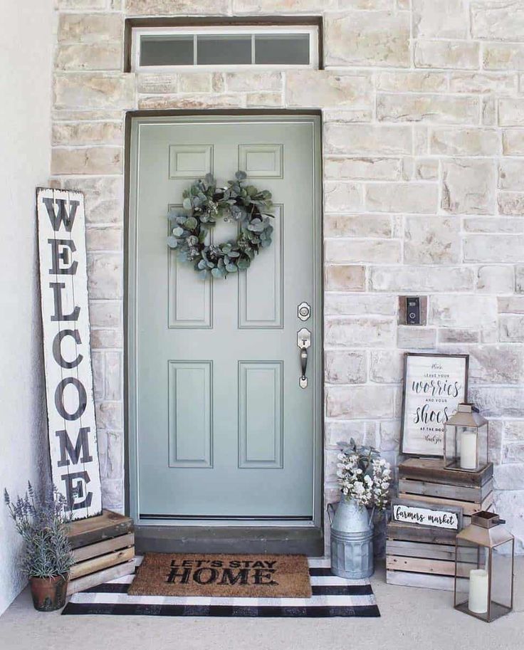 a front door with a welcome mat and wreath