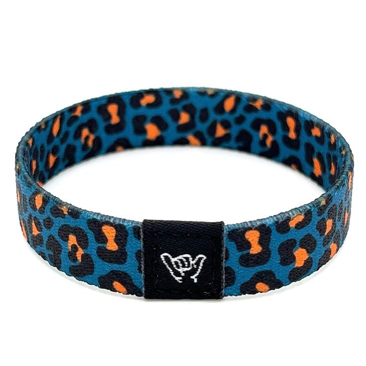 Jaguar Print Wristband Bracelet. Available sizes:  Extra Small 5.5" (petites + kids) Small 6.5" (most common fitting size) Medium 7.5" (large wrists) Large or Anklet 8.5" (very large wrists or anklet) 1/2" Width Reversible surf and beachy prints. Elastic blend material, can stretch to desired fit. Packaged in natural drawstring gift pouches. Machine washable. Chlorine and saltwater safe. Casual Wristband With Bracelet Strap For Friendship, Adjustable Band Bracelet, Adjustable Band Wristband With Bracelet Strap, Casual Band Bracelets For Friendship, Adjustable Blue Band Bracelets, Adjustable Casual Wristband, Blue Casual Stretch Bracelet For Festivals, Adjustable Festival Wristband, Adjustable Band Bracelet Casual Style