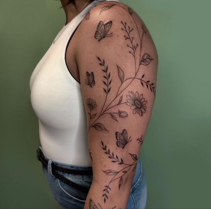 a woman with a butterfly tattoo on her arm