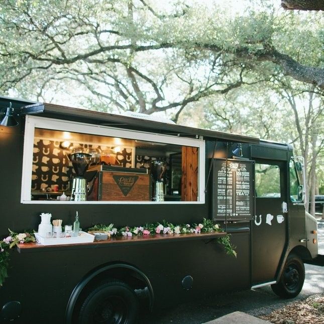 the food truck is parked on the side of the road