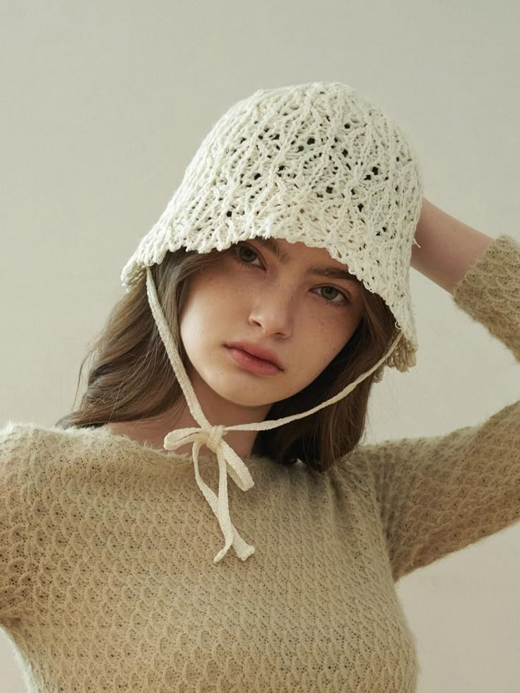 a woman wearing a white crochet hat