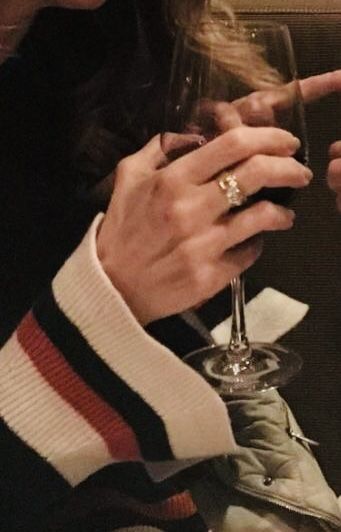 a woman holding a wine glass in her hand