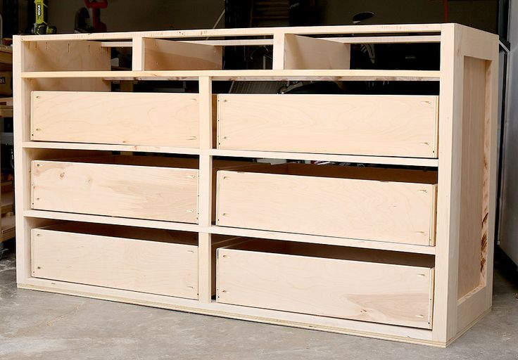 an unfinished dresser with drawers in the middle