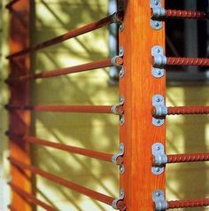 an orange wooden fence with metal bars on it