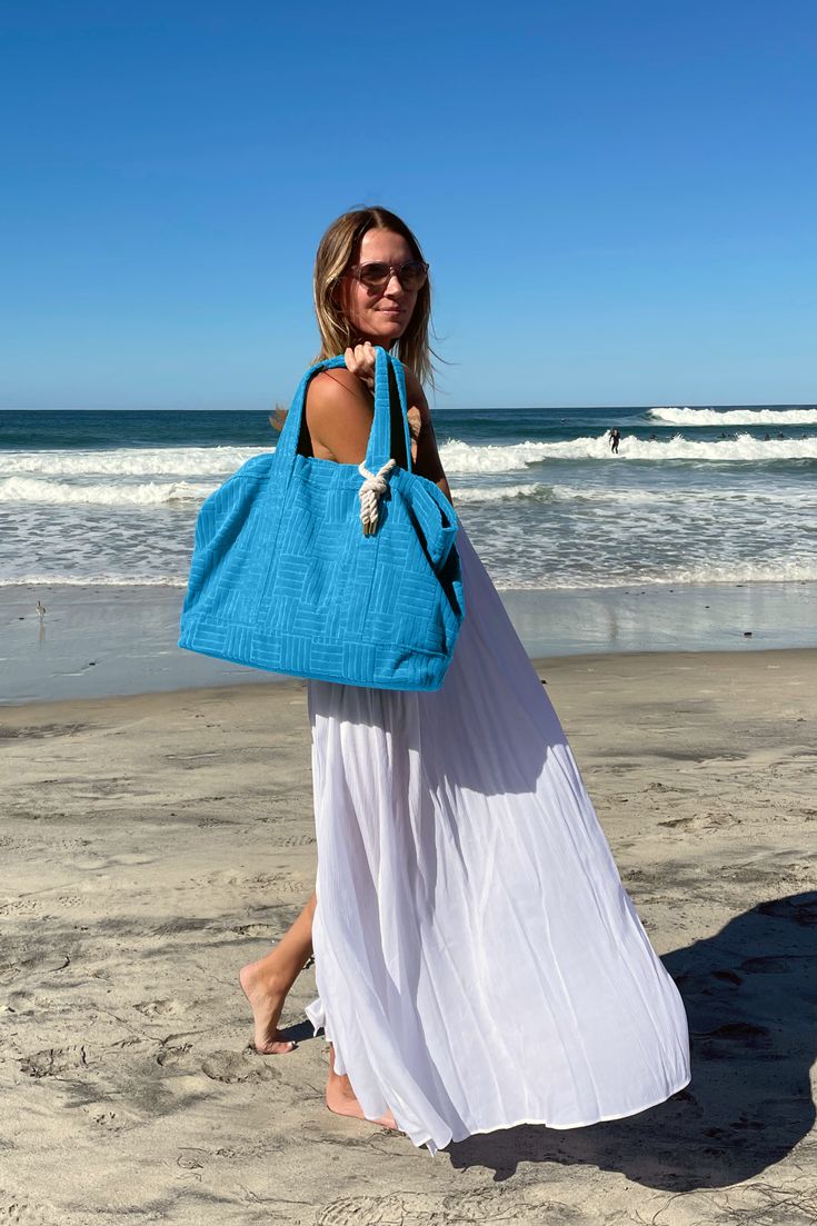 The Terry Weekender Set blends retro charm with modern functionality. This set includes a soft, textured terry tote and a matching clutch. The tote is perfect for stashing your beach essentials, while the clutch—complete with a detachable rope handle—makes a chic transition from day to night. Both pieces feature fun rope details, giving the set a whimsical, nautical vibe. This bag set is so awesome it made a Forbes chic summer bags list. 💙 Terrycloth exterior: Soft, fun, practical AND stylish. Trendy Beach Hobo Bag With Leather Handles, Trendy Hobo Bag With Leather Handles For Beach, Everyday Hobo Bag For Beach Season With Double Handle, Hobo Bag With Double Handle For Everyday Beach Use, Double Handle Hobo Bag For Everyday Beach Use, Chic Sand-colored Beach Bag For Everyday Use, Chic Beach Hobo Bag With Removable Pouch, Beach Tote Hobo Bag With Removable Pouch, Versatile Tote Hobo Bag For The Beach