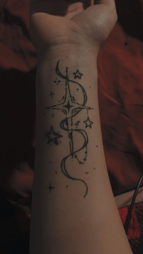 a person's arm with a tattoo on it that reads, and has stars