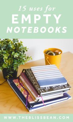 a stack of books sitting on top of a wooden table next to a potted plant