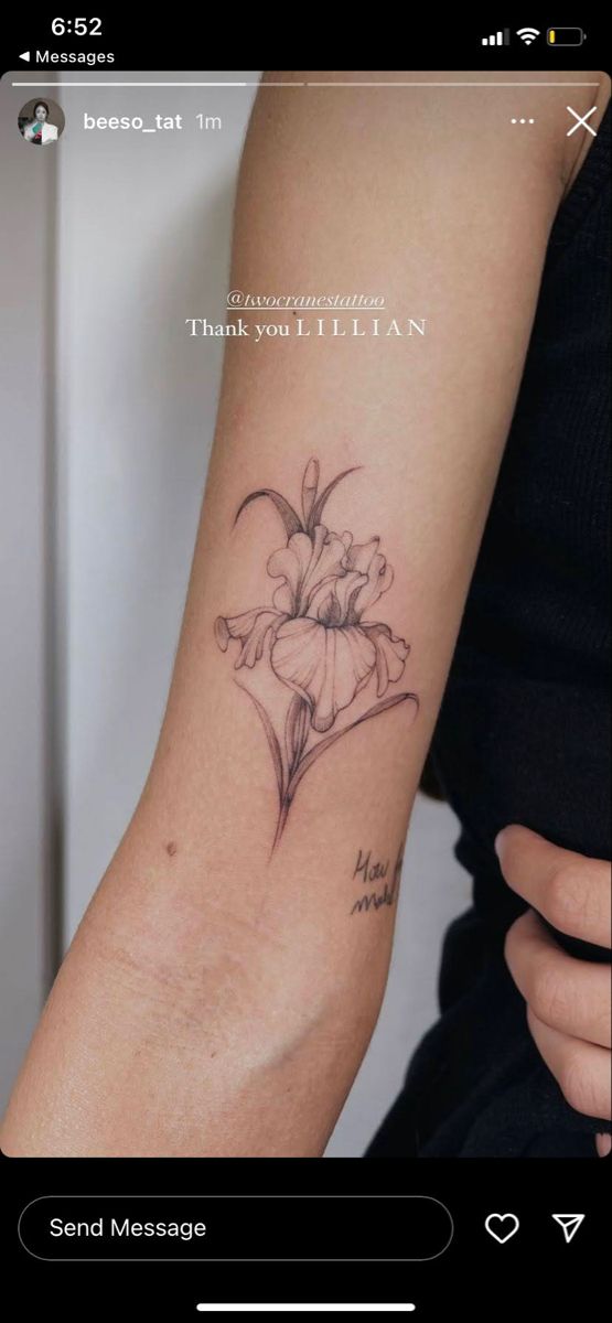 a woman's arm with a flower tattoo on the left side of her arm