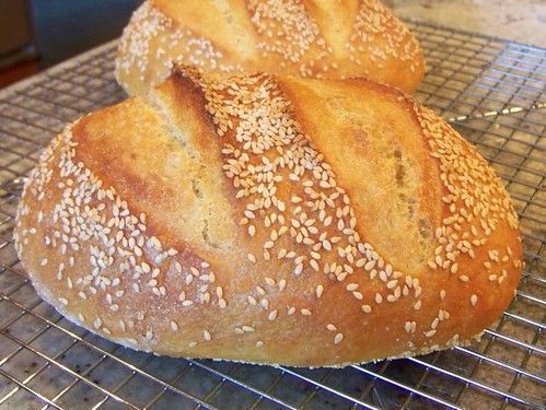 two loaves of bread sitting on a cooling rack