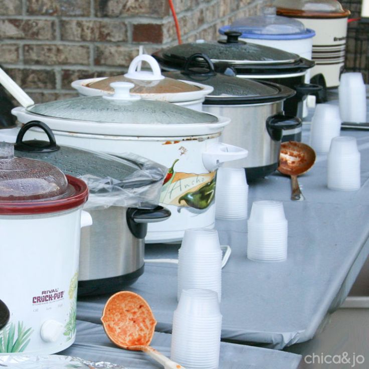 many pots and pans are lined up on a table