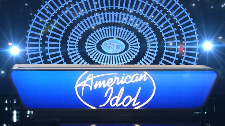 the american idol logo on stage at an awards show in front of a large wheel