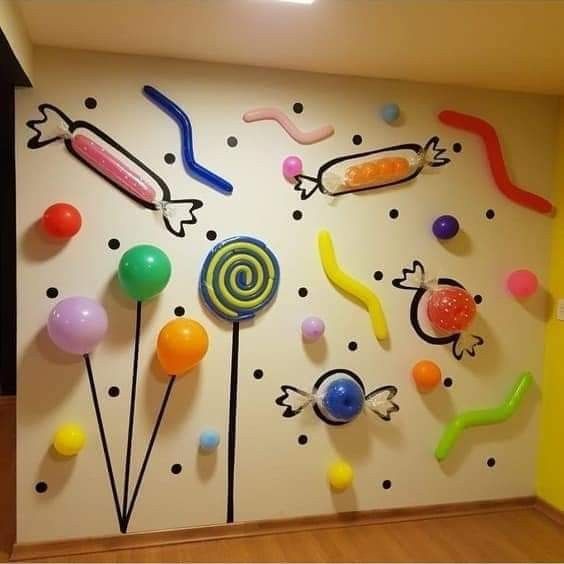 the wall is decorated with colorful candies and lollipops