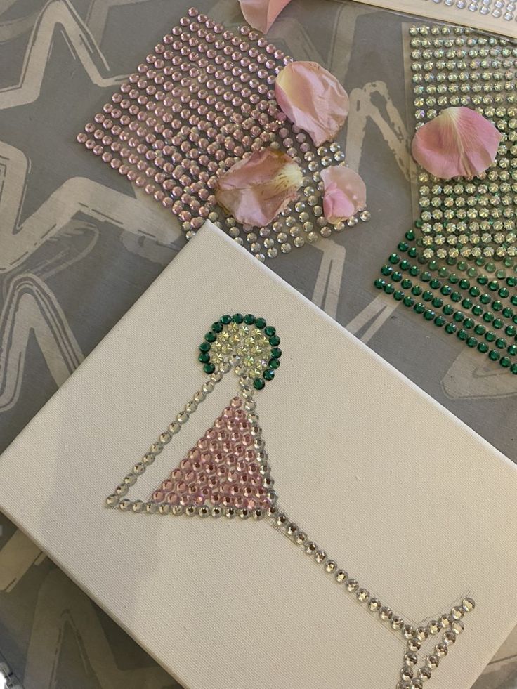 some beaded items are laying out on a table with pink flowers and other accessories