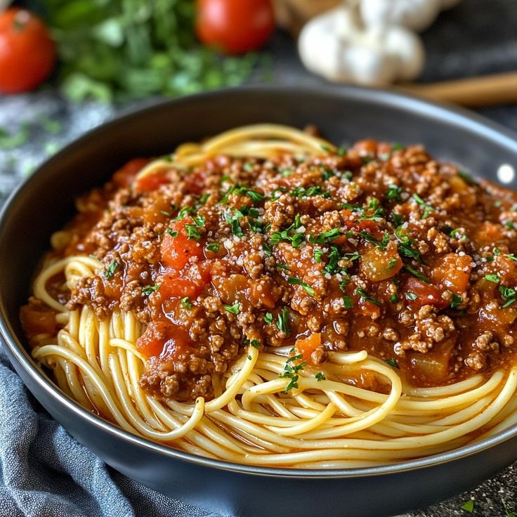 a bowl filled with spaghetti and meat sauce