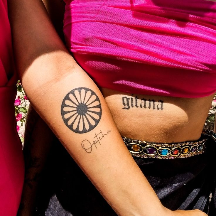 two women with tattoos on their arms and one has the word india written on it