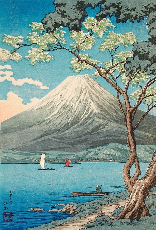 an image of a mountain with boats on the water and trees in front of it