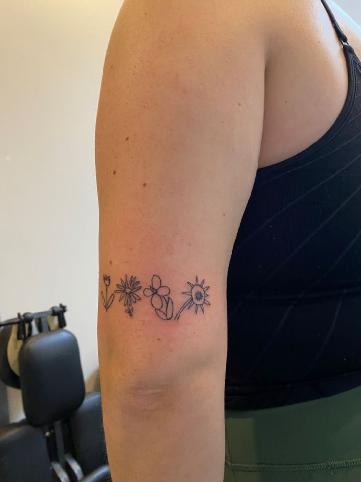 a woman with a flower tattoo on her arm