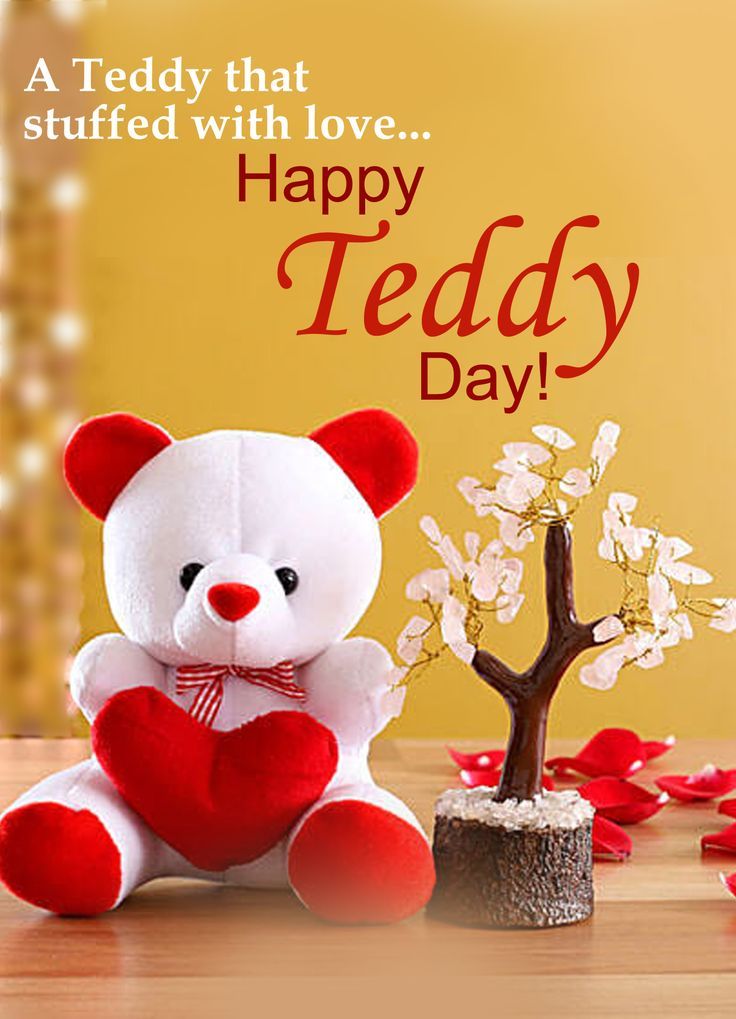 a teddy bear holding a heart sitting next to a small tree with petals on it