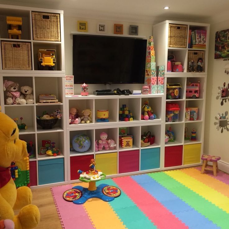 a child's playroom with toys and bookshelves