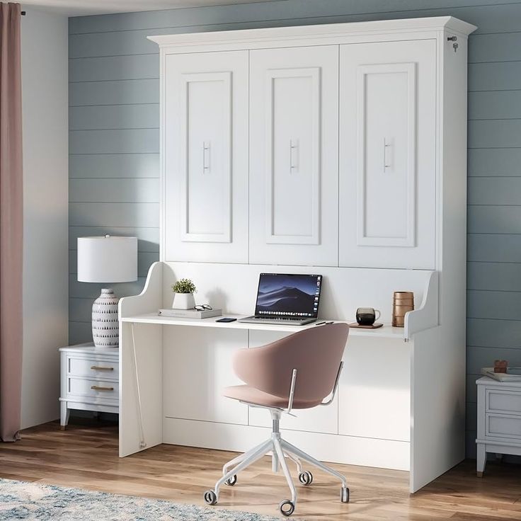 a white desk with a laptop computer on top of it next to a dresser and chair