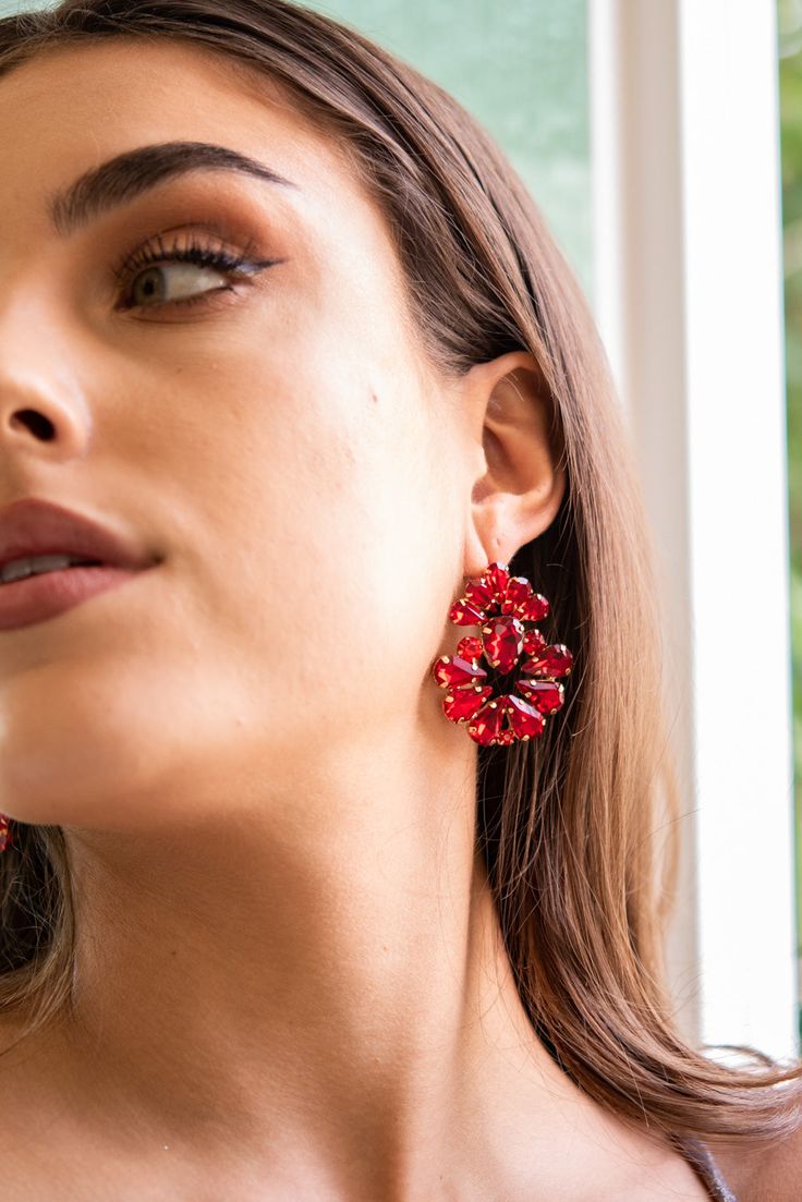 Add a touch of sophistication to your jewelry collection with the Valerie Floral Rhinestone Earrings. These earrings feature delicate floral designs, studded with shimmering rhinestones, for a stunning and elegant look. Perfect for special occasions or to elevate your everyday style. Shop now and get ready to turn heads with the Valerie Floral Rhinestone Earrings. Size Length: 1.75 in (4.45 cm)Width: 1.5 in (3.81 cm) Quality Made of metal and with rhinestones that are placed into a floral shape. Elegant Flower Beaded Earrings, Party Flower Crystal Earrings, Cubic Zirconia Cluster Drop Earrings For Party, Flower Shaped Hoop Earrings For Party, Flower Shaped Chandelier Earrings, Glamorous Flower-shaped Party Earrings, Glamorous Flower Bridal Earrings For Party, Red Flower Earrings For Party, Crystal Flower Earrings For Party