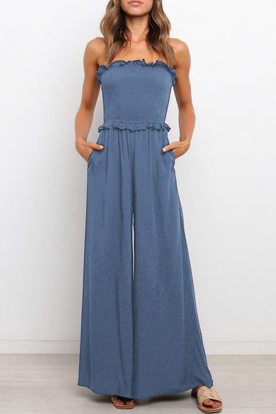 This Smocked Bandeau Wide Leg Jumpsuit is the perfect addition to your wardrobe. Crafted from 100% Polyester, this jumpsuit is designed to flatter your figure and provide you with a comfortable fit. The smocked bandeau top features a wide leg silhouette that is perfect for any occasion. The jumpsuit is available in a variety of colors, so you can find the perfect one to match your style. The wide leg design is perfect for showing off your curves and creating a slimming effect. The jumpsu... Summer Strapless Jumpsuits And Rompers With Elastic Waistband, Spring Vacation Strapless Jumpsuit With Smocked Bodice, Strapless Jumpsuits And Rompers With Elastic Waistband For Vacation, Solid Color Strapless Stretch Jumpsuit With Wide Leg, Stretch Strapless Jumpsuit With Wide Legs, Summer Bandeau Jumpsuits And Rompers With Elastic Waistband, Summer Bandeau Jumpsuit With Elastic Waistband, Bandeau Jumpsuits And Rompers With Elastic Waistband For Spring, Strapless Beach Jumpsuits With Smocked Bodice