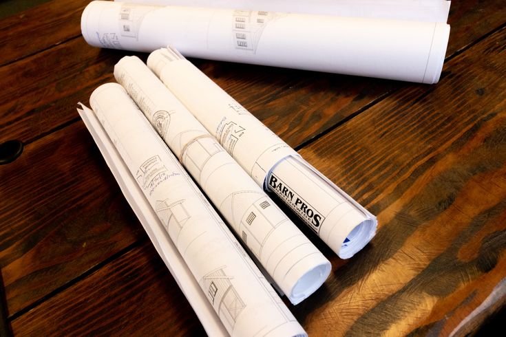 four rolls of paper sitting on top of a wooden table