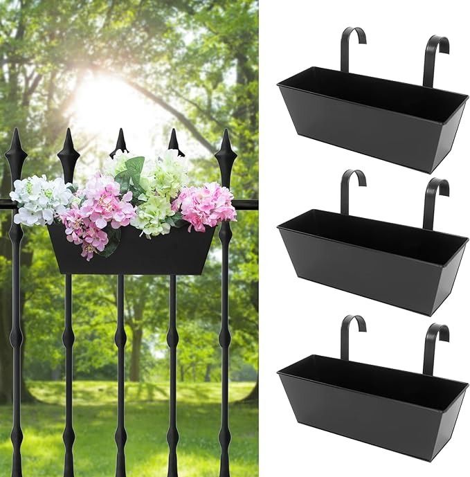 three black metal planters with flowers in them