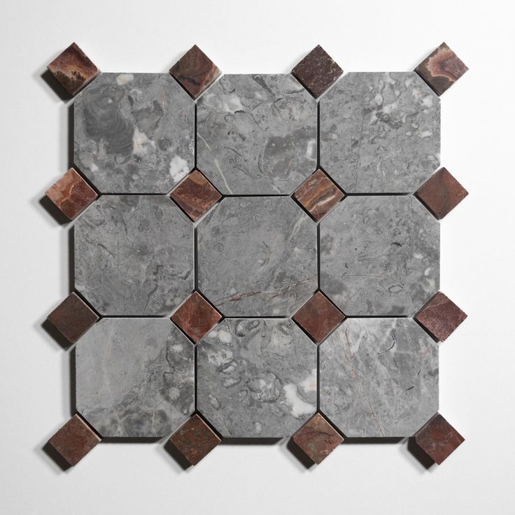 a marble tile with brown and white squares on it's sides, in the shape of hexagonals