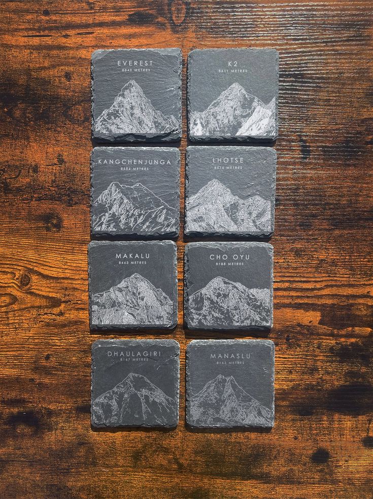 four slate coasters with mountain images on them