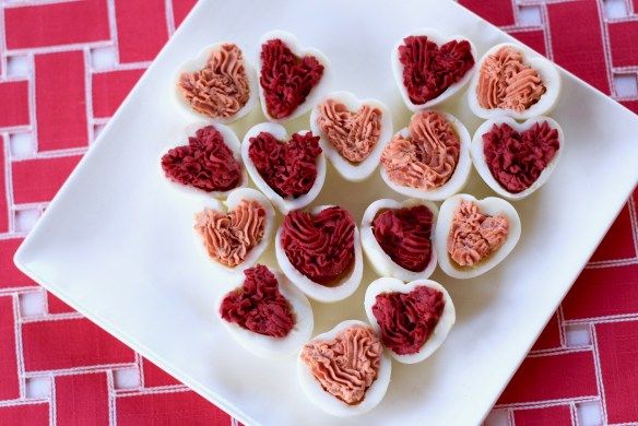 heart shaped deviled eggs on a white plate