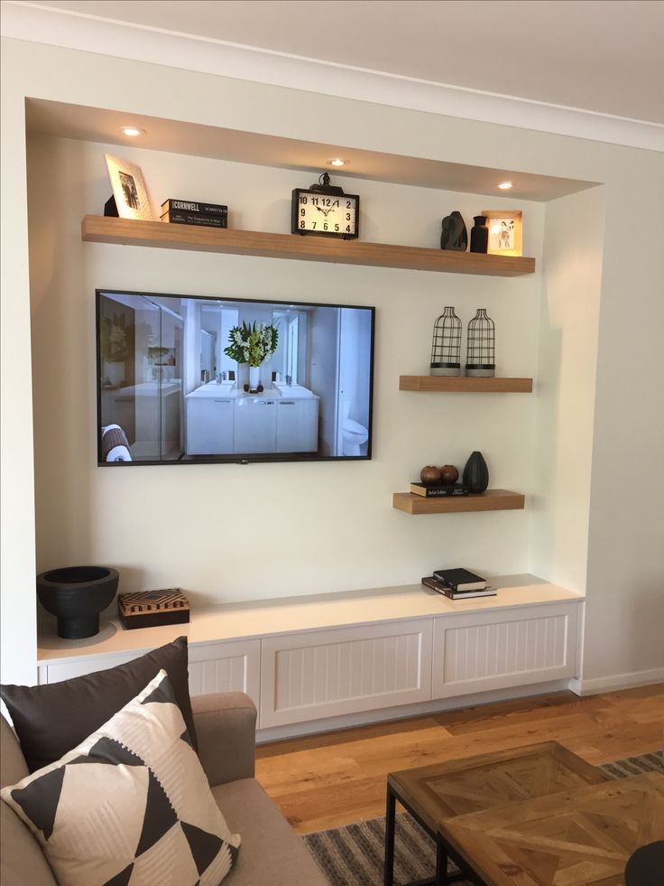 a flat screen tv mounted to the wall in a living room