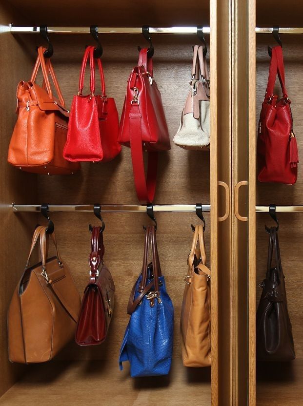 the purses are lined up on the shelves in the closet, and ready to be used