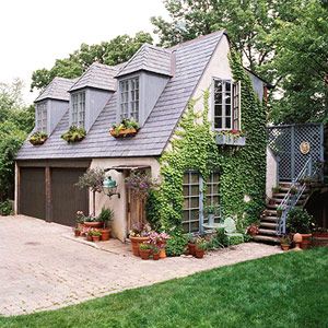 a large house with lots of windows and plants