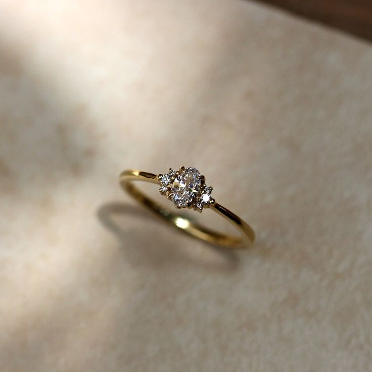 a diamond ring sitting on top of a table