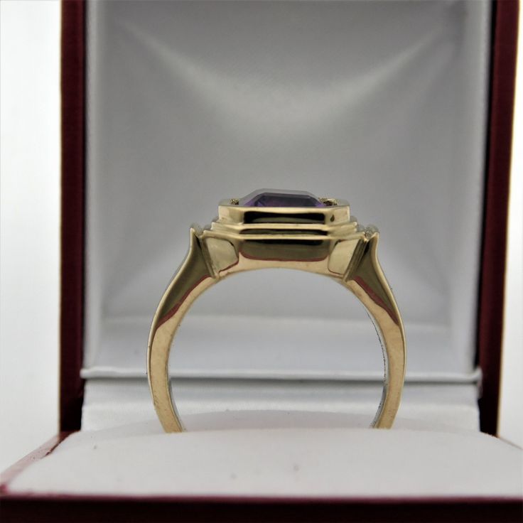 Gemstone: Amethyst Treatments: None Specifications: 10x8mm, 3.05 carats Color: As shown. Clarity: Transparent, no visible inclusions Cut: Emerald cut Origin: Brazil This is a stunning amethyst. Please note: these rings are made to order, so you will notice that all the center stones are shown positioned on the ring mounting. This is a fine and classy example of what a bold masculine ring should look like. Perfect for a man, yet not too masculine that a woman could not get away with wearing it. T Formal Yellow Gold Ruby Ring, Yellow Gold Octagon Signet Ring For Formal Occasions, Formal Yellow Gold Ruby Ring With Polished Finish, Polished Yellow Gold Sapphire Ring For Formal Occasions, Polished Yellow Gold Sapphire Ring For Formal Events, Formal Yellow Gold Amethyst Ring With Bezel Setting, Formal Yellow Gold Sapphire Ring With Polished Finish, Amethyst Anniversary Ring With Halo Setting In Yellow Gold, Anniversary Rings With Polished Octagon Shape