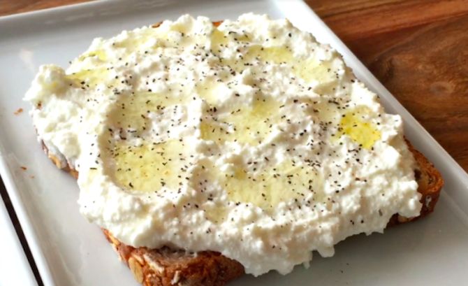 a white plate topped with food on top of a wooden table