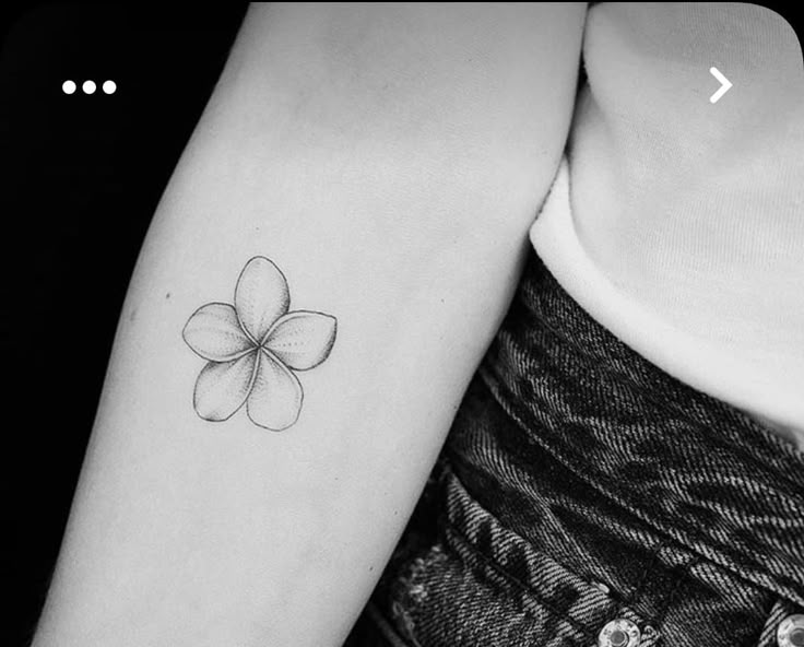 a four leaf clover tattoo on the left arm