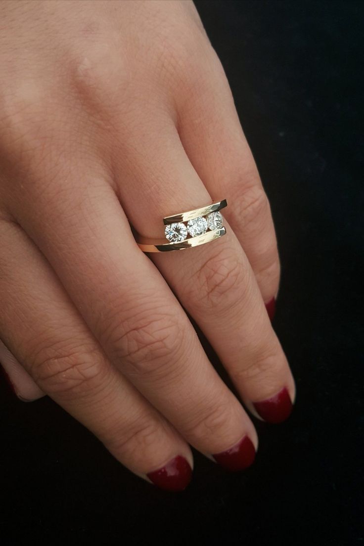 a woman's hand with two rings on it