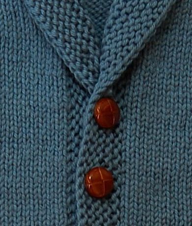 a blue sweater with two buttons on it