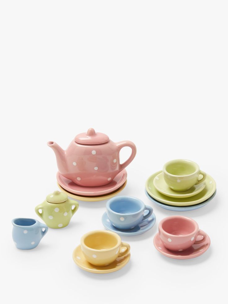 various colored cups and saucers with polka dots on them