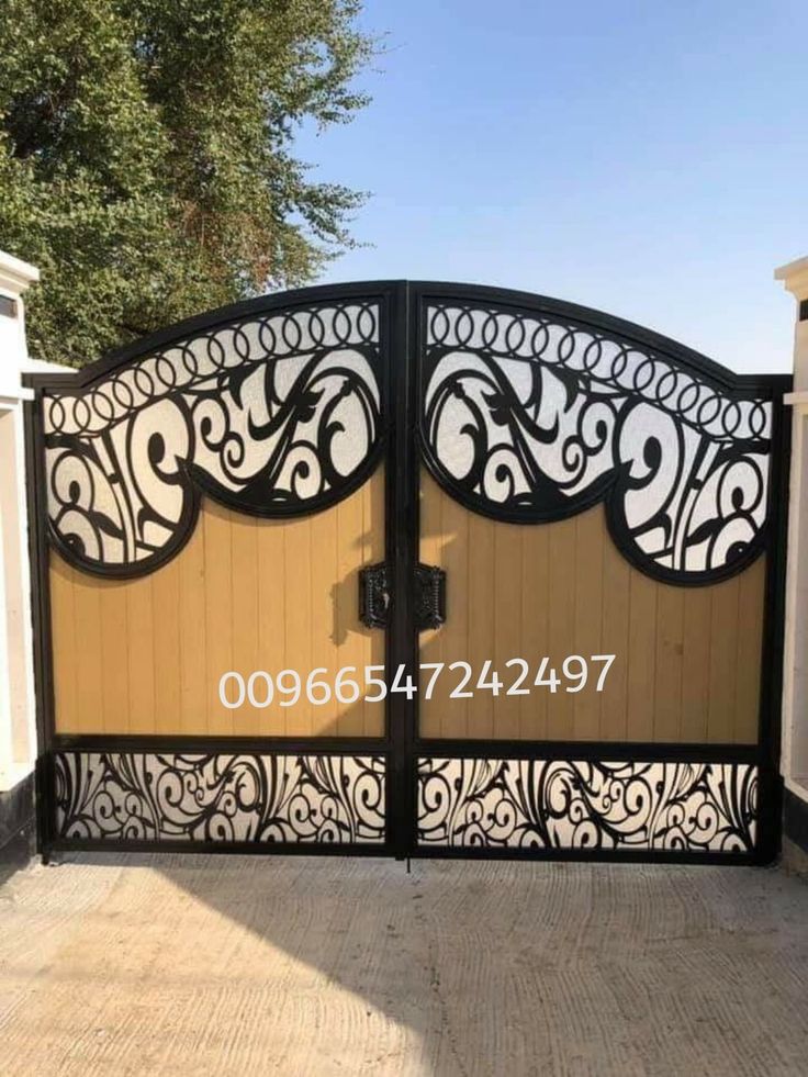 an iron gate with decorative designs on it