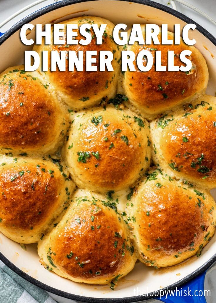 cheesy garlic dinner rolls in a skillet with text overlay that reads cheesy garlic dinner rolls