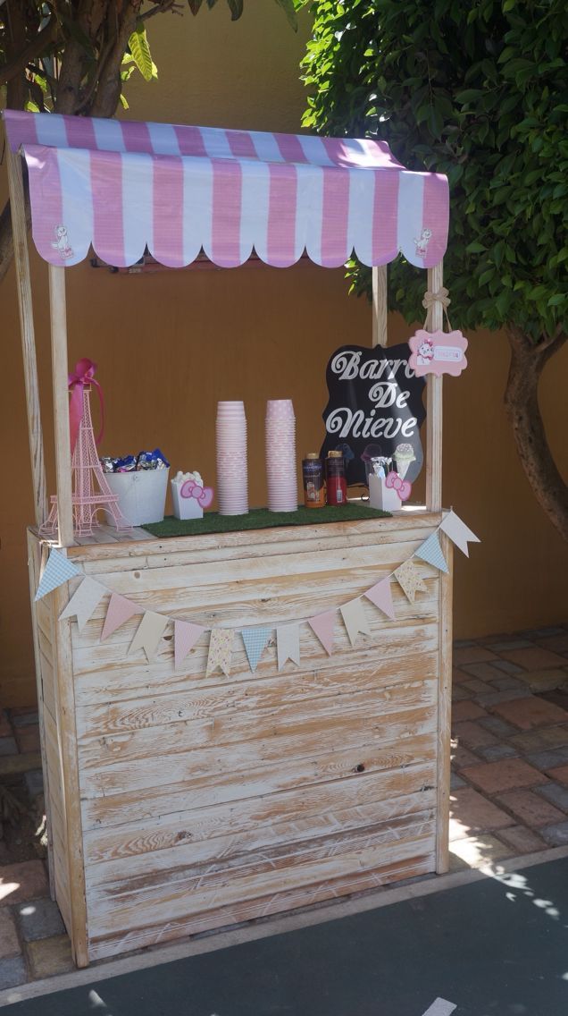 a pink and white striped ice cream stand