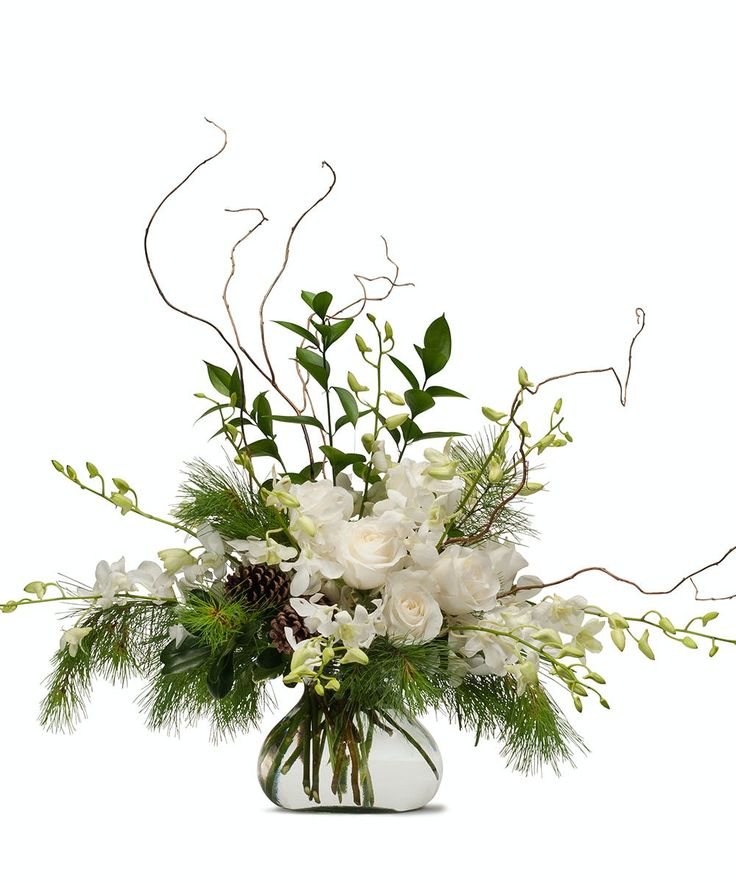 a vase filled with white flowers and greenery