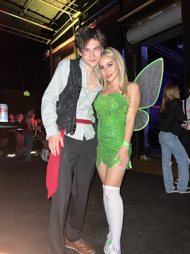 a man and woman dressed up as tinkerbells