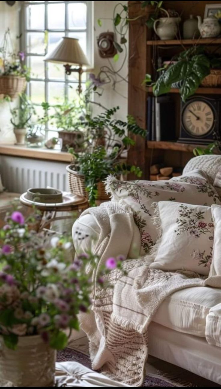 a living room filled with furniture and lots of plants