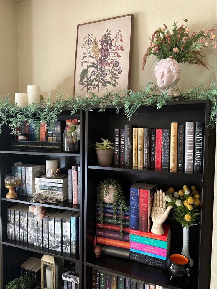 a bookshelf filled with lots of books and plants