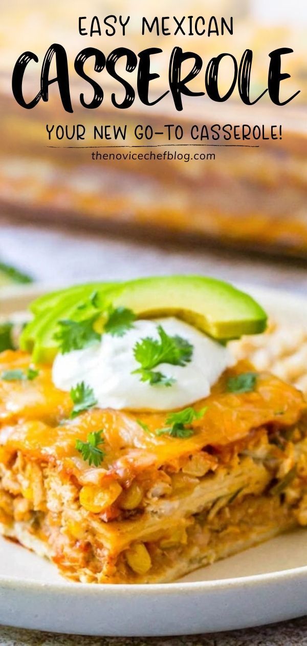 mexican casserole on a plate with avocado and sour cream in the background