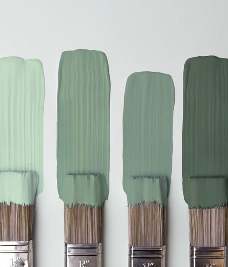 three paintbrushes with different shades of green